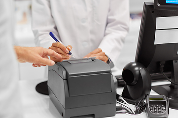 Image showing pharmacist and customer at cash register