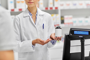 Image showing pharmacist and customer with medicine at pharmacy