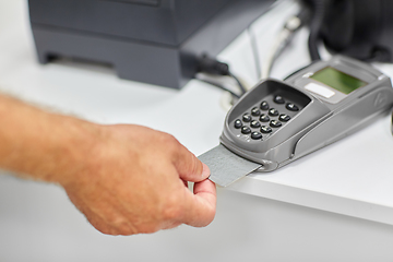 Image showing close up of hand with credit card in card-reader