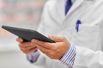 Image showing close up of senior pharmacist with tablet pc