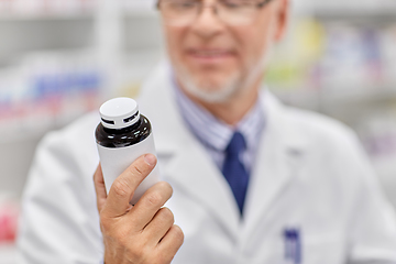 Image showing close up of pharmacist with medicine at pharmacy