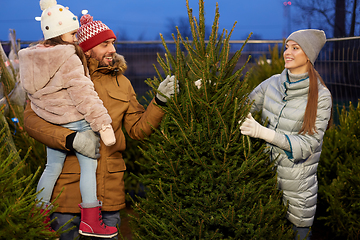 Image showing happy family choosing christmas tree at market