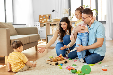 Image showing happy family palying with wooden toys at home