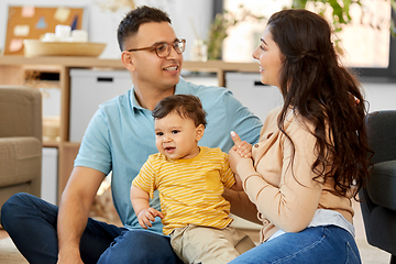 Image showing happy family with child sitting on sofa at home