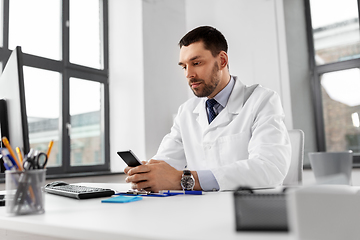 Image showing male doctor with smartphone at hospital