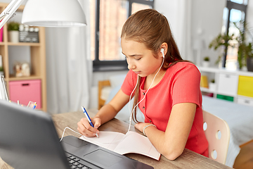 Image showing student girl in earphones learning at home