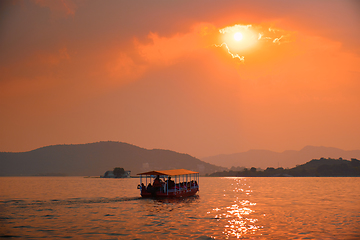 Image showing Boat in lake Pichola on sunset. Udaipur, Rajasthan, India