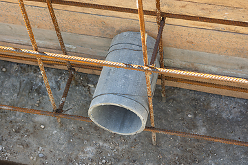 Image showing Construction of a strip foundation, laying a sleeve for communications