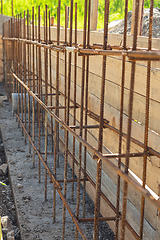 Image showing Construction of a strip foundation, reinforcement strapping, formwork in the background