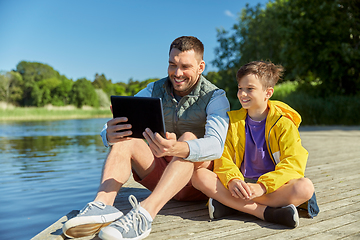 Image showing happy father and son with tablet pc on river berth