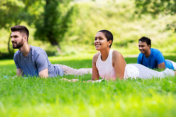 Image showing group of people doing yoga at summer park