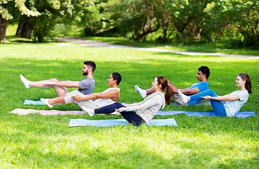 Image showing group of people doing yoga at summer park