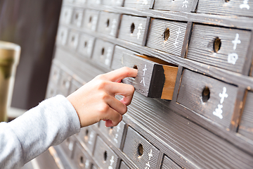 Image showing Hand taking out from drawer