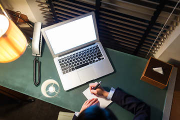 Image showing Top view of businesswoman taking note on the desk