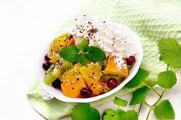 Image showing Salad fruit with cranberries in bowl on napkin