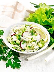 Image showing Salad of cabbage with radish in plate on table