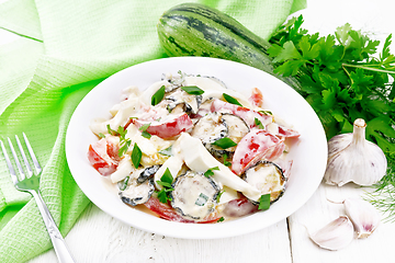 Image showing Salad with fried zucchini in plate on light board