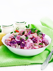 Image showing Salad with herring and beetroot in bowl on towel