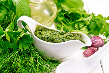 Image showing Sauce of spicy greens in gravy boat on board