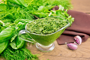 Image showing Sauce of spicy greens in gravy boat on old wooden board