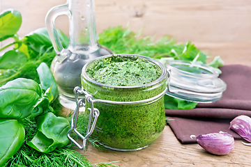 Image showing Sauce of spicy greens in jar on old board