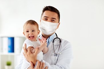 Image showing doctor or pediatrician in mask with baby at clinic