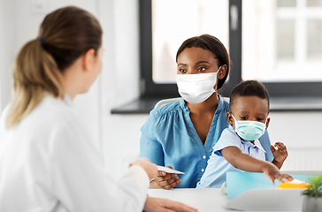 Image showing mother with baby son in masks and doctor at clinic