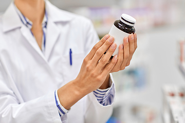 Image showing close up of pharmacist with medicine at pharmacy