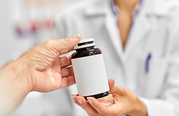 Image showing pharmacist and customer with medicine at pharmacy