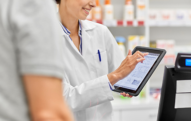 Image showing female pharmacist with prescription on tablet pc