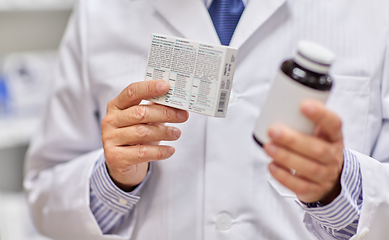 Image showing close up of pharmacist with medicine at pharmacy