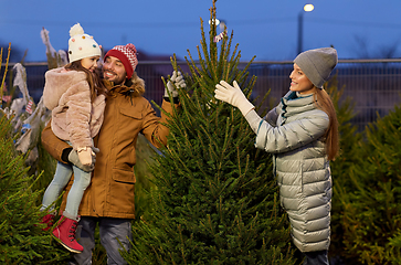 Image showing happy family choosing christmas tree at market