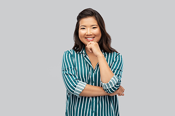 Image showing happy asian woman over grey background