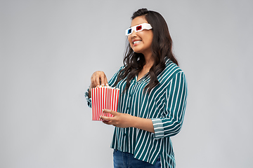 Image showing asian woman in 3d movie glasses eating popcorn