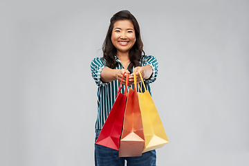 Image showing happy asian woman with shopping bags