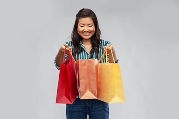 Image showing happy asian woman with shopping bags