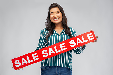 Image showing happy smiling young asian woman with sale banner