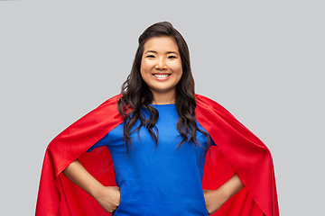 Image showing happy asian woman in red superhero cape