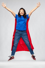 Image showing happy asian woman in red superhero cape jumping