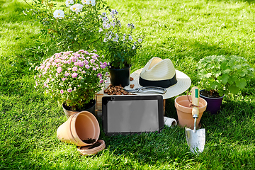 Image showing tablet pc, garden tools and flowers at summer