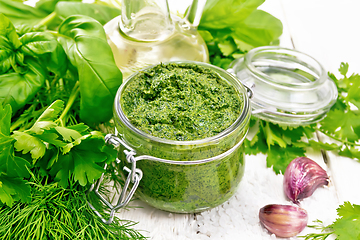 Image showing Sauce of spicy greens in jar on white board