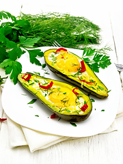 Image showing Scrambled eggs with peppers in avocado on board