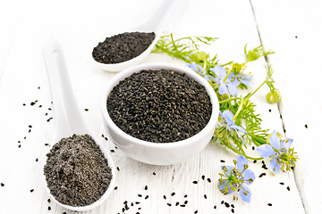 Image showing Seeds of black cumin in bowl on light board