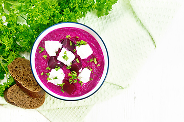 Image showing Soup puree of beetroot with feta in bowl on board top