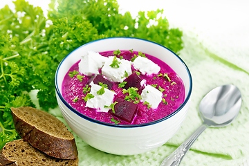 Image showing Soup puree of beetroot with feta in bowl on board