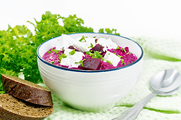 Image showing Soup puree of beetroot with feta in bowl on light board