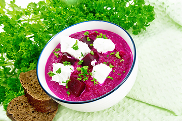 Image showing Soup puree of beetroot with feta in bowl on wooden board