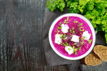 Image showing Soup puree of beetroot with salted cheese in bowl on black board