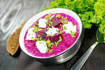 Image showing Soup puree of beetroot with salted cheese in bowl on black board