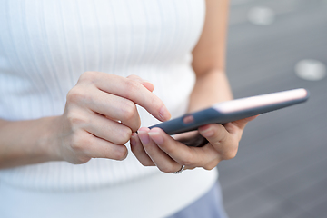 Image showing Woman finger touch on mobile phone